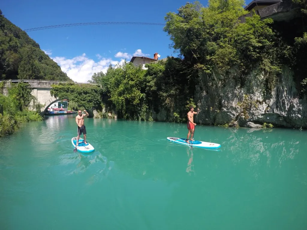 Go paddleboarding on emerald water of Soča
